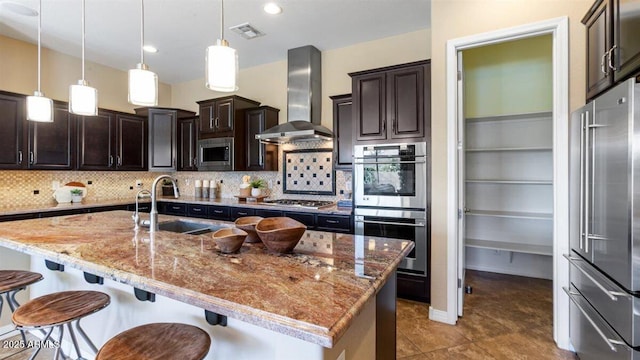 6917 E Ingram Cir, Mesa, AZ 85207 - kitchen featuring stainless steel appliances, wall chimney exhaust hood, a breakfast bar area, and light stone counters