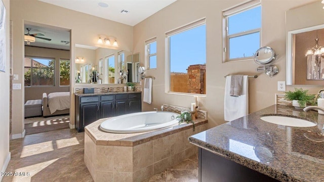 6917 E Ingram Cir, Mesa, AZ 85207 - bathroom featuring two vanities, a bath, ceiling fan, and tile patterned flooring