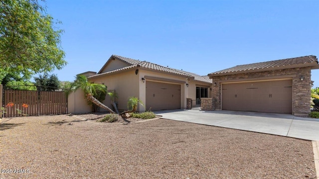 6917 E Ingram Cir, Mesa, AZ 85207 - view of front facade with a garage, concrete driveway, stucco siding, a tiled roof, and a gate