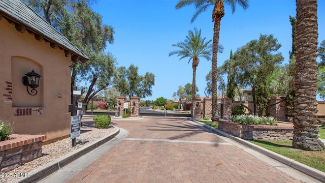 6917 E Ingram Cir, Mesa, AZ 85207 - view of decorative road featuring curbs, a gated entry, and a gate