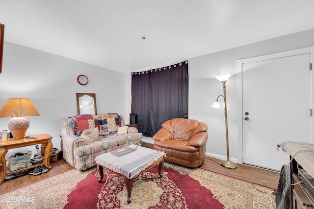 living room featuring baseboards and wood finished floors