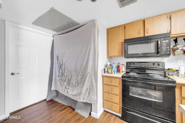 kitchen with black appliances, wood finished floors, visible vents, and light countertops