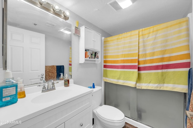 full bath featuring vanity, a shower stall, toilet, and visible vents