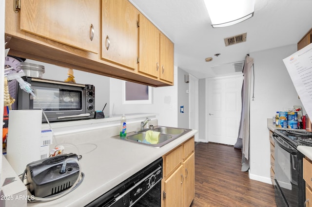 kitchen featuring visible vents, light countertops, dark wood-style floors, black appliances, and a sink