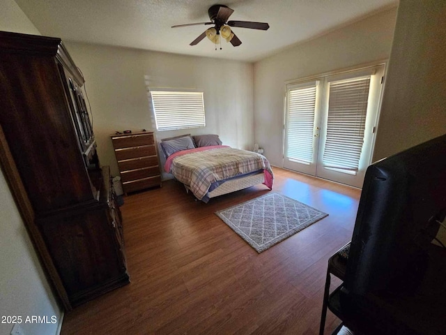 bedroom with access to outside, ceiling fan, and wood finished floors