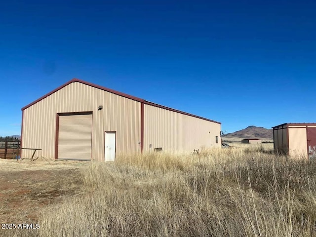 view of outbuilding featuring a mountain view and an outbuilding
