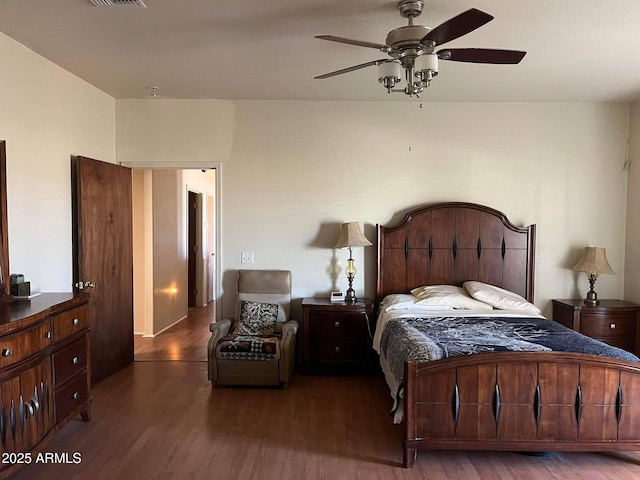 bedroom with visible vents, ceiling fan, and wood finished floors