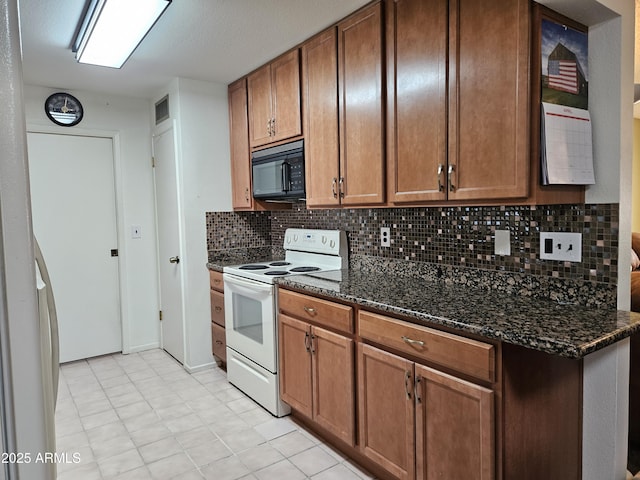 kitchen with brown cabinetry, decorative backsplash, electric range, black microwave, and dark stone countertops