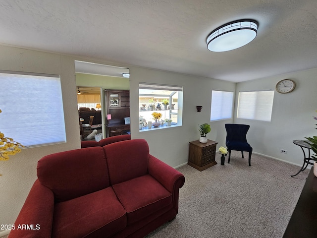 carpeted living room featuring baseboards