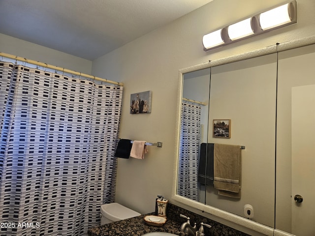 full bathroom with vanity, a shower with curtain, and toilet