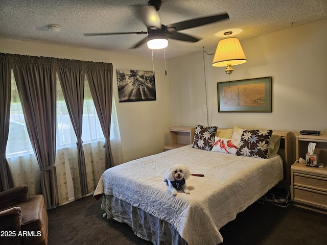 carpeted bedroom featuring a ceiling fan and a textured ceiling