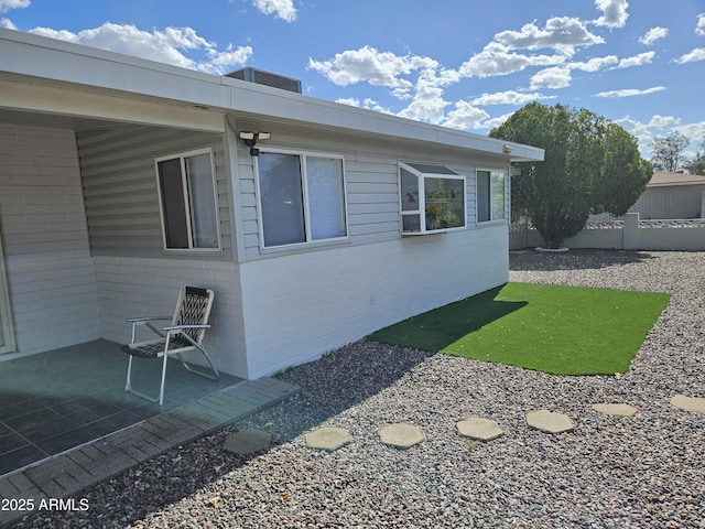 view of home's exterior featuring fence and a patio