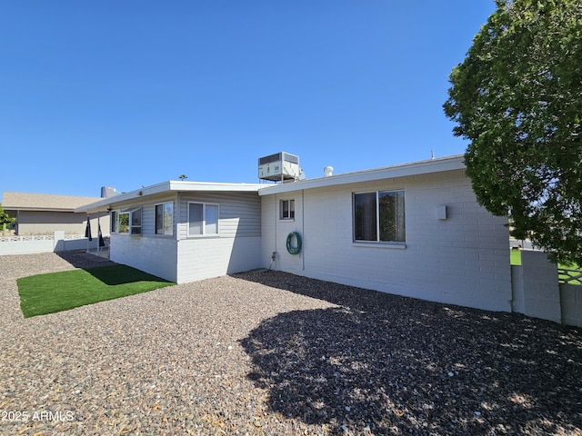 back of property with fence, a patio, and central AC