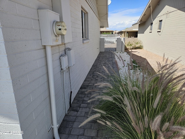 view of side of property with a gate