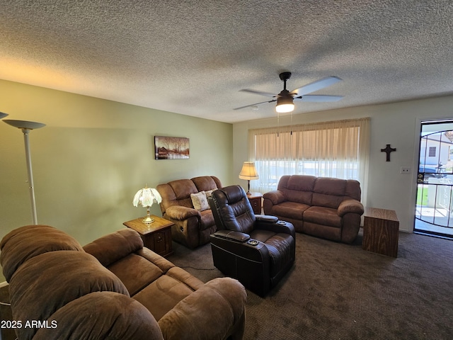 carpeted living area featuring a textured ceiling and ceiling fan