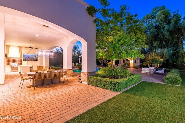 view of patio featuring exterior kitchen and ceiling fan