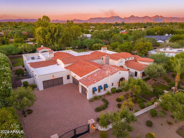 aerial view at dusk featuring a mountain view