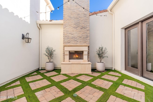 view of patio / terrace with an outdoor fireplace