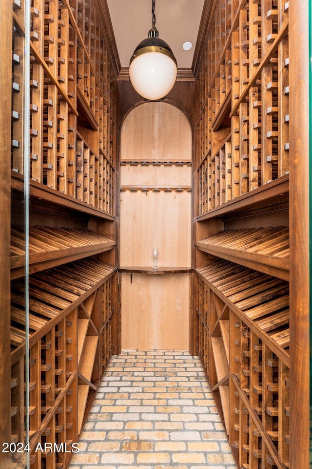 wine room with ornamental molding