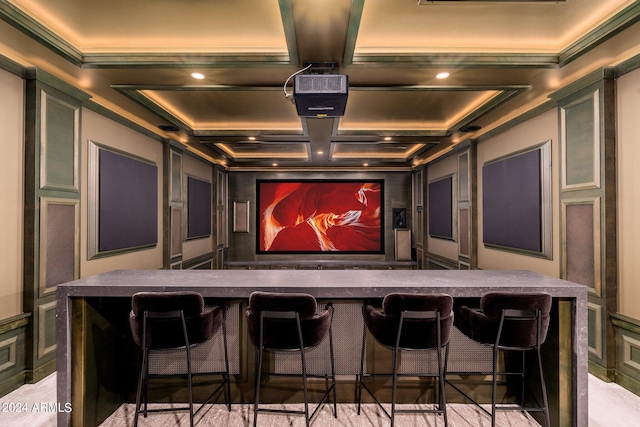 cinema with beam ceiling, ornamental molding, and coffered ceiling