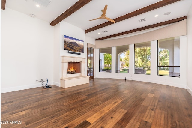 unfurnished living room featuring dark wood-type flooring and beam ceiling