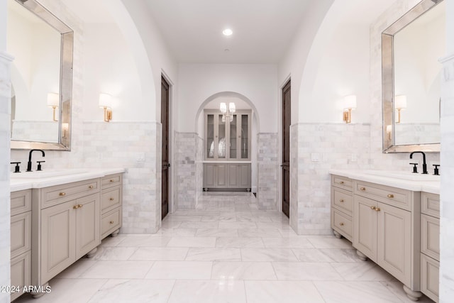 bathroom with vanity and tile walls