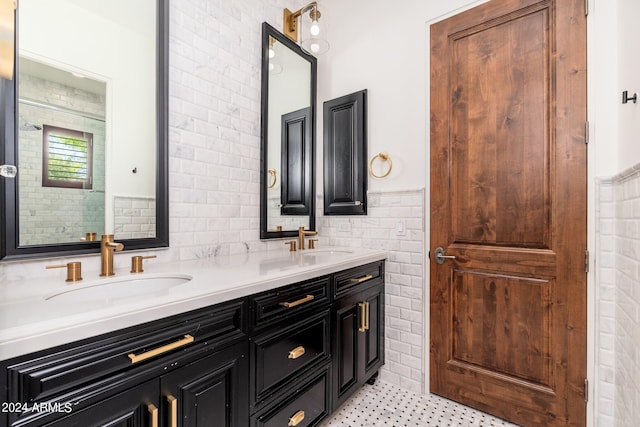 bathroom featuring vanity and tile walls