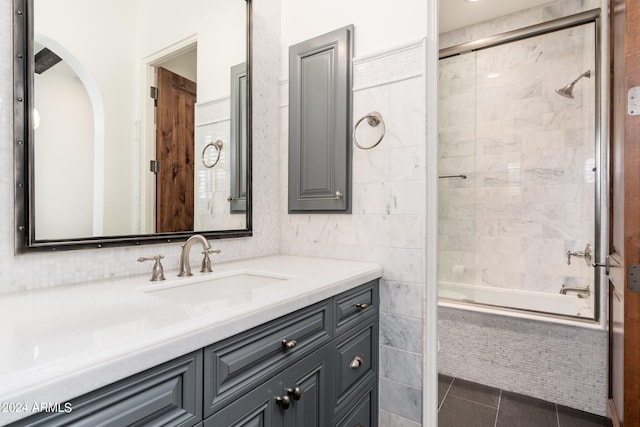 bathroom with vanity, enclosed tub / shower combo, and tile patterned flooring