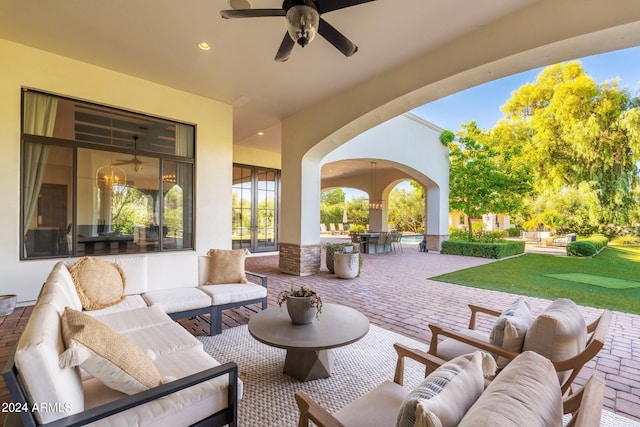 view of patio with ceiling fan and an outdoor living space