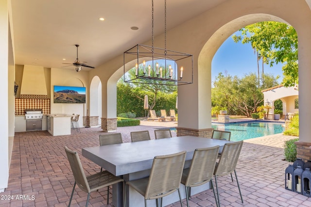 view of patio with area for grilling, ceiling fan, and an outdoor kitchen