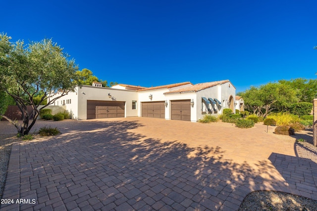 mediterranean / spanish-style home featuring a garage