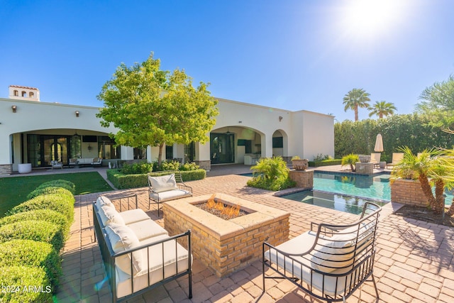 view of patio / terrace with an outdoor living space with a fire pit