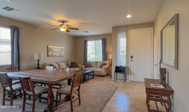 dining area featuring light tile patterned floors, visible vents, and ceiling fan