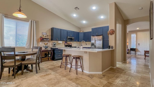 kitchen featuring arched walkways, visible vents, blue cabinetry, and stainless steel appliances