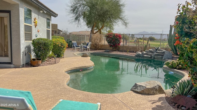 view of swimming pool featuring a patio area, a fenced in pool, and a fenced backyard