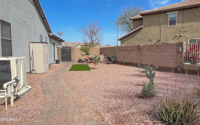 view of yard featuring central air condition unit, a gate, and a fenced backyard