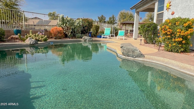 view of pool with a fenced in pool, a patio area, and fence