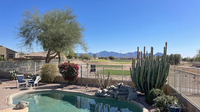 view of pool featuring a mountain view, a fenced in pool, a fenced backyard, and a patio area