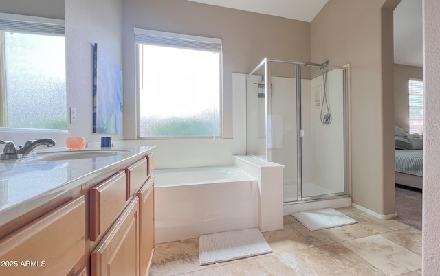 bathroom with a bath, a shower stall, and vanity