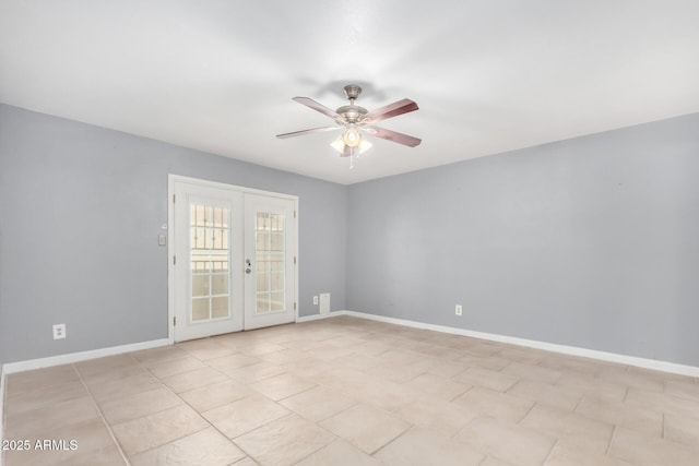 spare room with ceiling fan and french doors