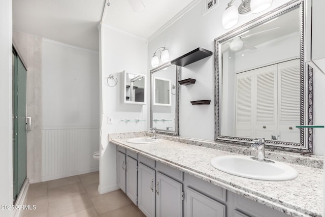 bathroom with vanity, tile patterned floors, crown molding, toilet, and a shower with shower door