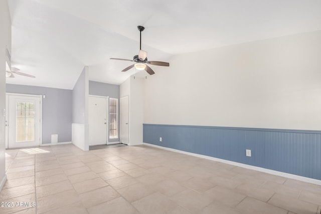 tiled spare room featuring ceiling fan and lofted ceiling