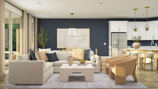 living room with light hardwood / wood-style floors and sink