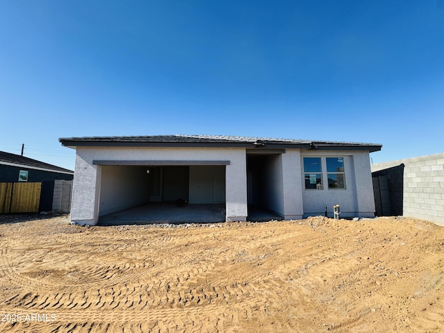 view of front of home with fence and stucco siding