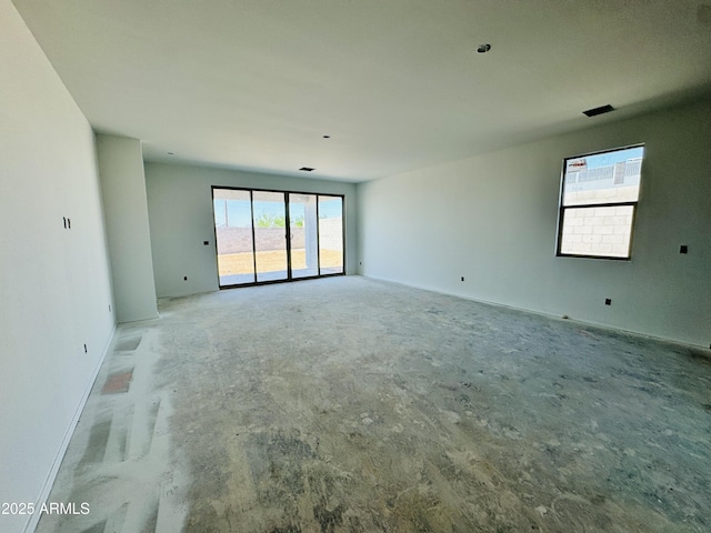spare room with baseboards