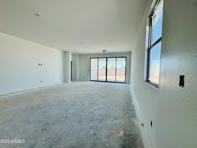 unfurnished room featuring concrete flooring