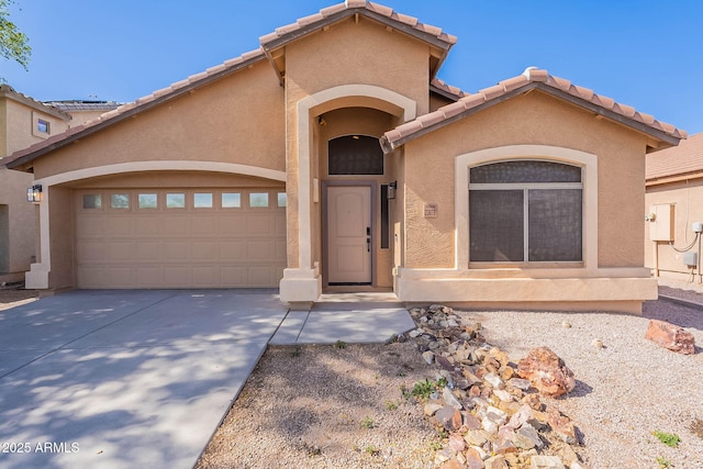 23676 W Parkway Dr, Buckeye, AZ 85326 - mediterranean / spanish-style house with driveway, stucco siding, an attached garage, and a tiled roof