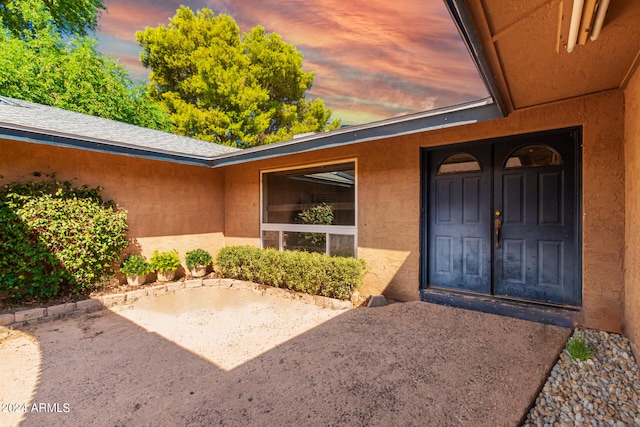 view of exterior entry at dusk