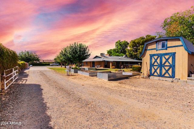 view of front of home featuring a storage shed