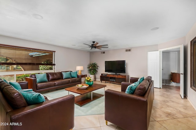 living room featuring ceiling fan and light tile patterned floors